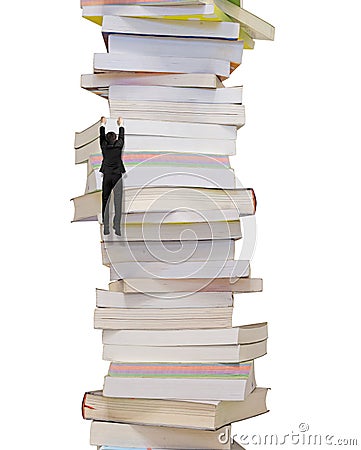 High stack of books with climbing businessman hang on it Stock Photo