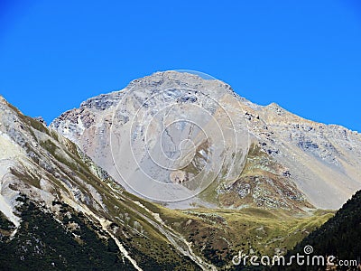 High swiss alpine peak Lenzerhorn (2906 m) above the tourist-agricultural village Alvaneu Bad (Alvagni Bogn) Stock Photo