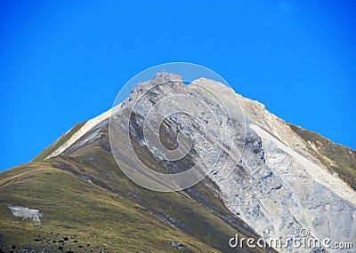 High swiss alpine peak Piz Mulain (2627 m) above the tourist-agricultural village Alvaneu Bad (Alvagni Bogn) Stock Photo