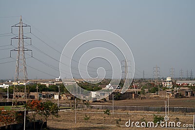 High Tension Electricity Pylons water tank and an under development township Stock Photo