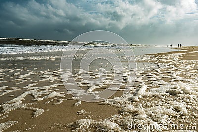 High Tide Beach Foam Seaspray with People Stock Photo