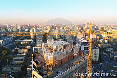 High tower building construction site. Bug industrial crane. Aerial drone view. Metropolis city development Stock Photo