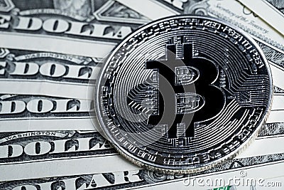 High value Bitcoin Crpto currency coin on US dollar banknotes Stock Photo