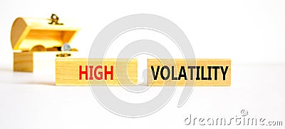 High volatility symbol. Concept words High volatility on beautiful wooden blocks. Beautiful white table white background. Wooden Stock Photo