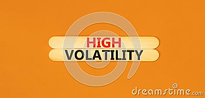 High volatility symbol. Concept words High volatility on beautiful wooden stick. Beautiful orange table orange background. Stock Photo