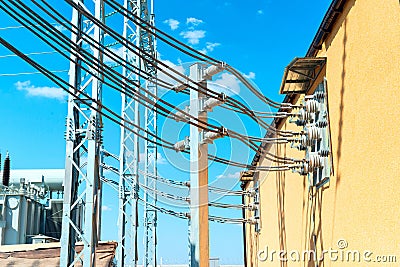 High-voltage aluminum wires coming out of the building of distribution equipment Stock Photo