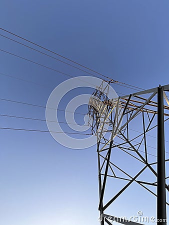 High voltage cable tower during sunset on a mountain Stock Photo