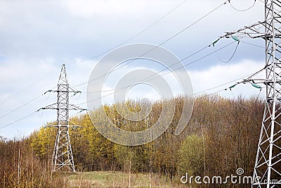 High voltage electric high voltage electric transmission power tower with electric glass insulator of over cloudy stormy Stock Photo