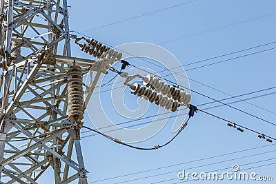 High-voltage electrical insulator electric line against the blue sky Stock Photo