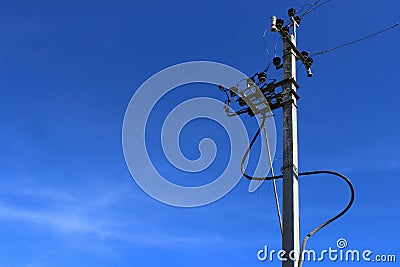 High Voltage Electricity Pillars Cables On Electricity Power Tower On Blue Sky Background. Transmission Lines. Stock Photo