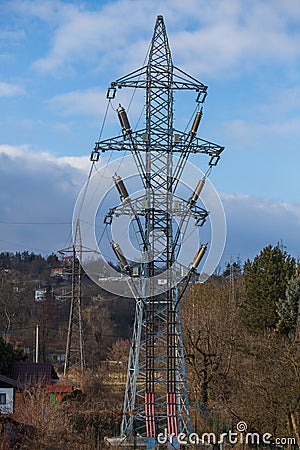 High voltage pole. The column stands in the middle of the gardens. The blue sky is in the background Stock Photo