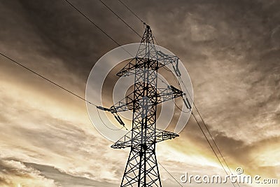 High voltage pole metal tower gray stormy sky electricity delivery to a distance Stock Photo