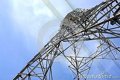 low angle view of steel framework of high voltage tower pole with electricity transmission power lines Stock Photo