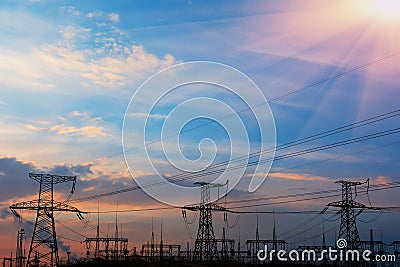 High-voltage power lines at sunset. electricity distribution station. high voltage electric transmission tower. Stock Photo