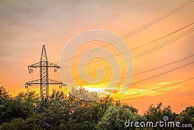 High voltage power transmission tower with electrical energy wires Stock Photo