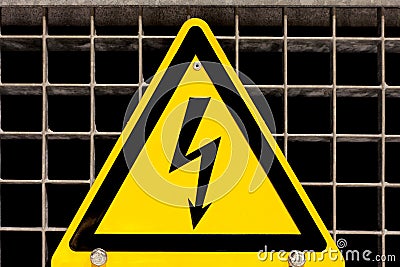 High Voltage Sign bolted on steel grid Stock Photo