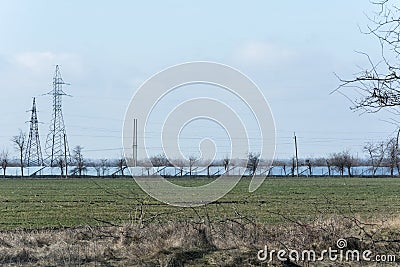 High-voltage towers power lines and lines of solar panels Stock Photo