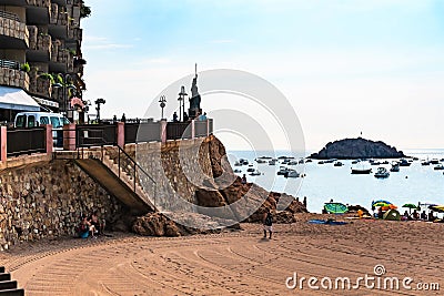 Tossa de Mar, Spain, August 2018. Sandy beach near the promenade and view of the bay. Editorial Stock Photo