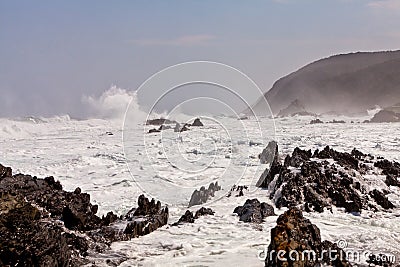 High wave breaking on the rocks Stock Photo