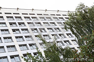 High white building facade with tree on foreground. Stock Photo