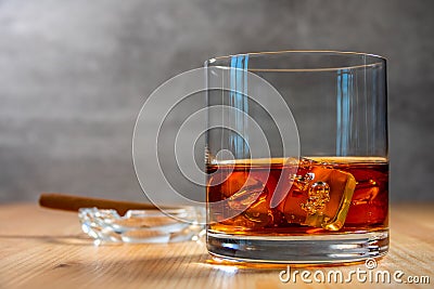 Highball of Whiskey With Ice and an Ashtray With a Cigar Stock Photo