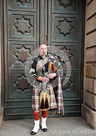 Highland dress is the traditional, regional dress of the Highlands and Isles of Scotland. It is often characterized by tartan Editorial Stock Photo