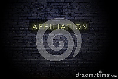 Highlighted brick wall with neon inscription affiliation Stock Photo