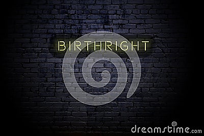 Highlighted brick wall with neon inscription birthright Stock Photo