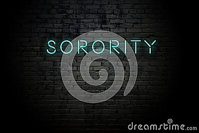 Highlighted brick wall with neon inscription sorority Stock Photo