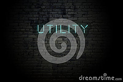 Highlighted brick wall with neon inscription utility Stock Photo