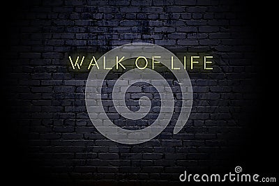 Highlighted brick wall with neon inscription walk of life Stock Photo