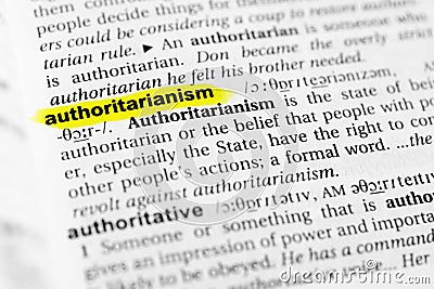 Highlighted English word `authoritarianism` and its definition in the dictionary Stock Photo
