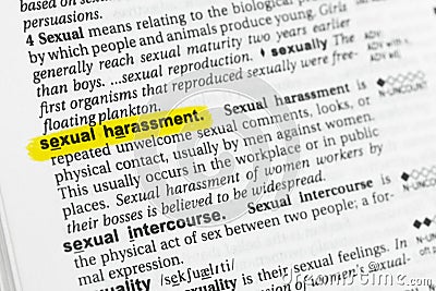 Highlighted English word sexual harassment and its definition at the dictionary. Stock Photo