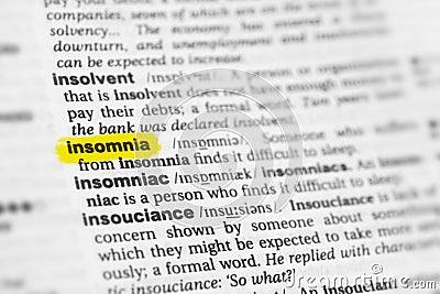 Highlighted English word & x22;insomnia& x22; and its definition at the dictionary Stock Photo