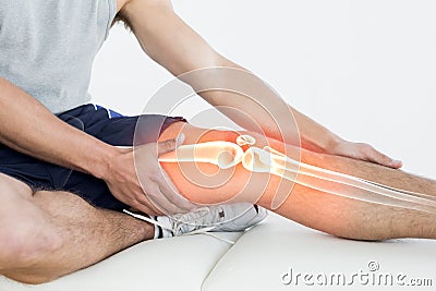 Highlighted knee of injured man Stock Photo