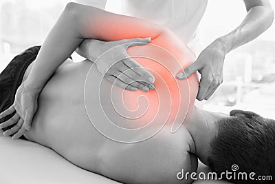 Highlighted shoulder of man at physiotherapy Stock Photo