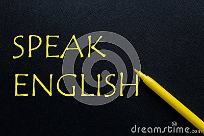 Highlighter Yellow Pen with yellow text Speak English at the black background Stock Photo