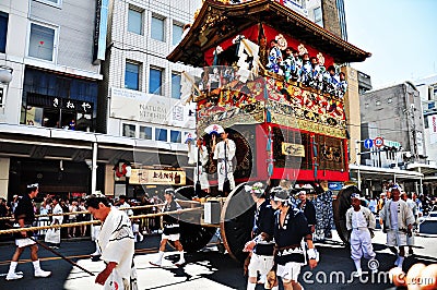 A highly decorated float along with its accompanying men in trad Editorial Stock Photo