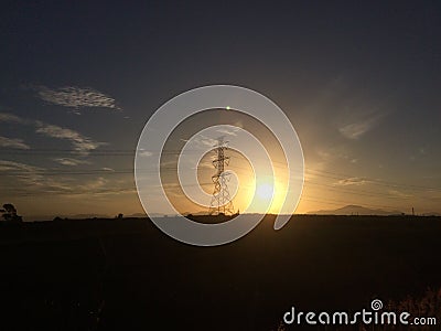 Hight volte electric tower with sunrise. Stock Photo