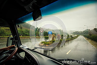 Highway along Tropical Plants under Heavy Rain out of Bus Window Stock Photo