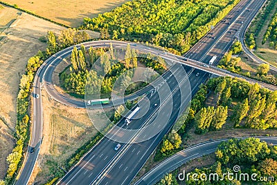 Highway from a bird's eye view. As the sun goes down, the sun's rays create beautiful long shadows on the ground. Stock Photo