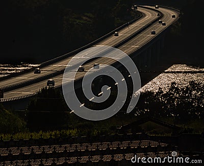 Highway bridge illuminated at twilight with the Rias Baixas below illuminated by the sun and the TaragoÃ±a Stock Photo
