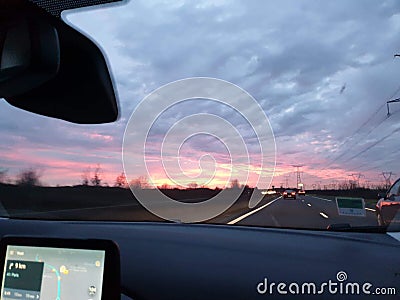 Highway leading to a moody sunset sky Stock Photo