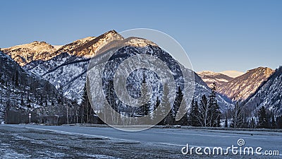 The highway runs along the mountain slopes. Stock Photo