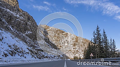 The highway runs along steep mountains Stock Photo