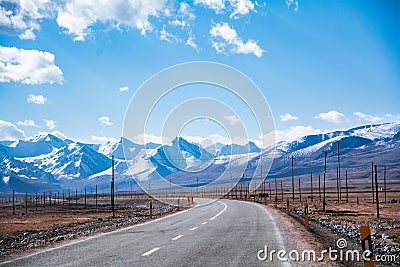 Highway by the snow mountain in high altitude region Stock Photo