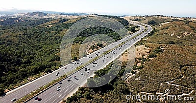 Highway 280 traffic on a Summer afternoon with Fog Rolling over Crystal Springs Reservoir