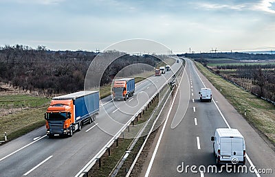 Highway Transportation traffic with Convoy of trucks passing on a highway Stock Photo