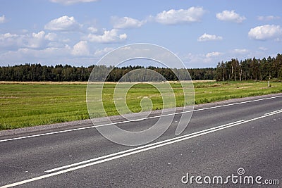 A highway under blue sky with clouds of white Stock Photo