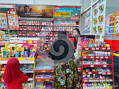 hijab girl Customer in front of cashier to pay inside Alfamart (Local Indonesia minimarket retail store Editorial Stock Photo